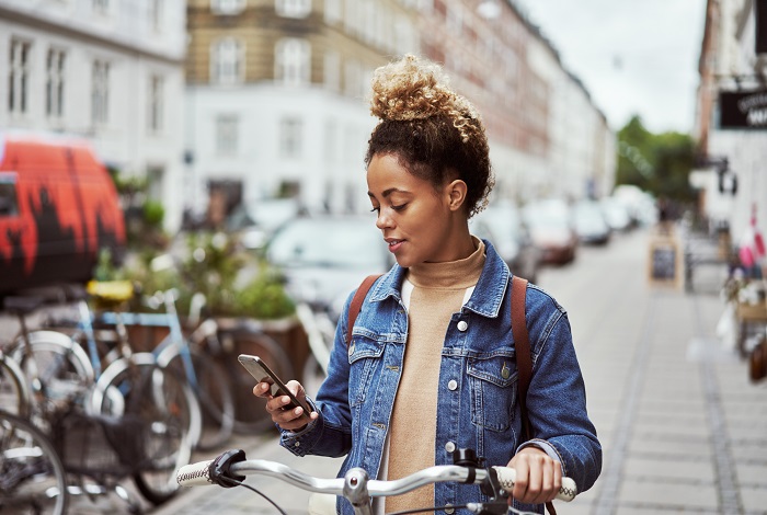 Woman looking at the Delta Community Mobile App on her phone