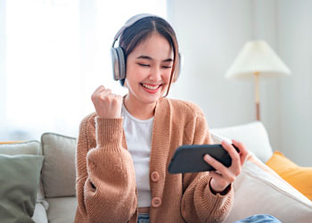 woman with headphones viewing smartphone