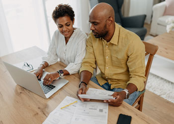 couple at laptop managing bills