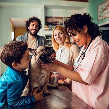 Family at vet with dog