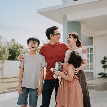 family in front of house