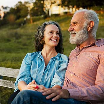 couple sitting on bench and smiling