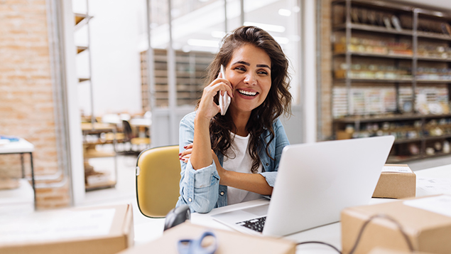 young woman at computer on the phone