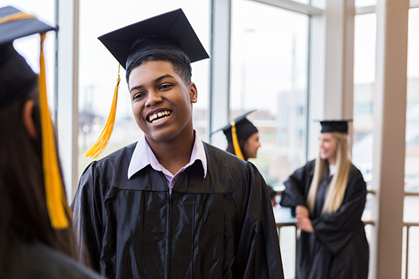 young man in graduation cap and gown